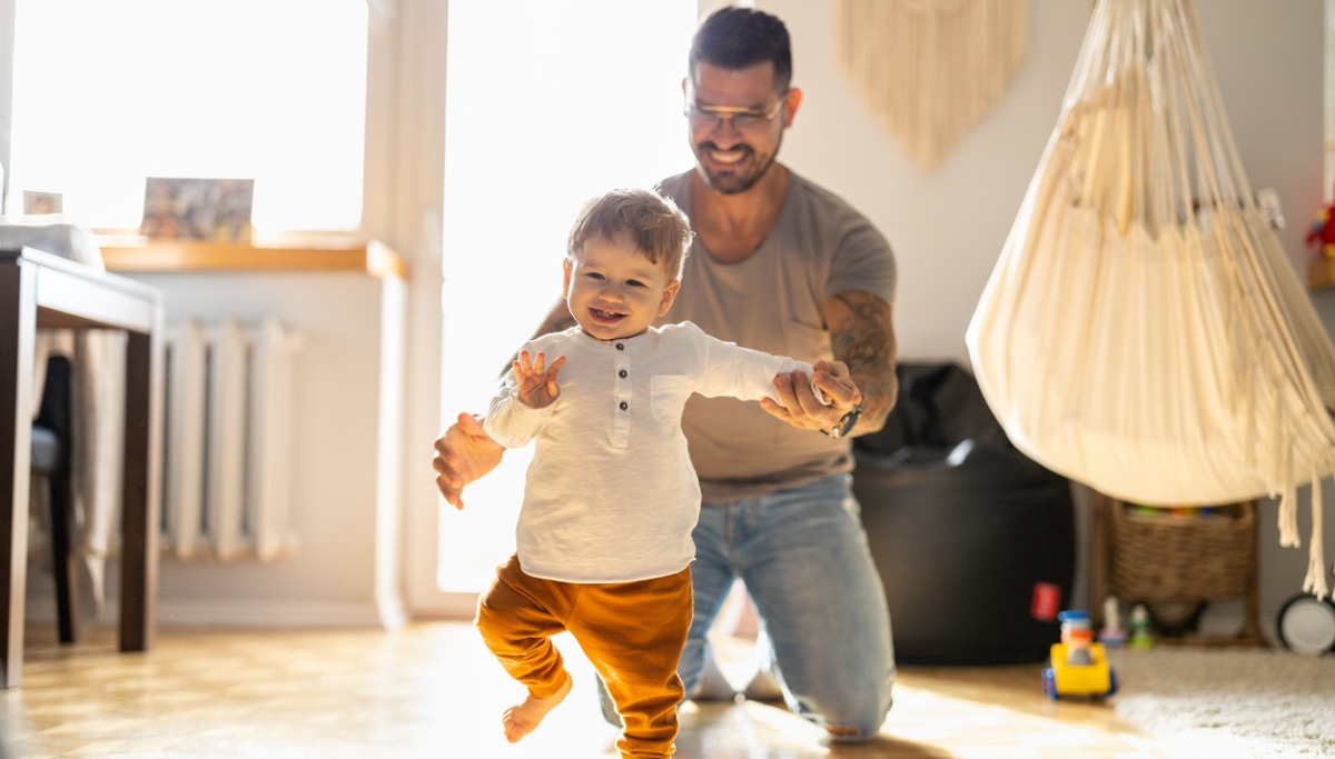 A father teaching his son to walk
