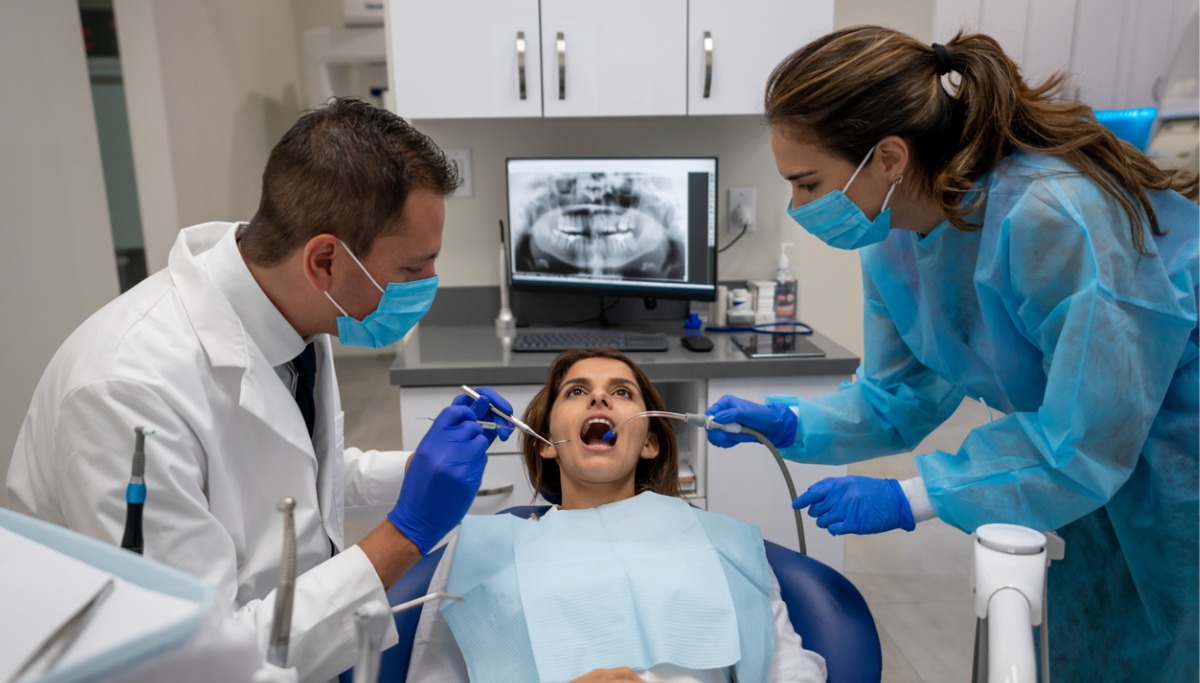A dentist and assistant conducting a procedure