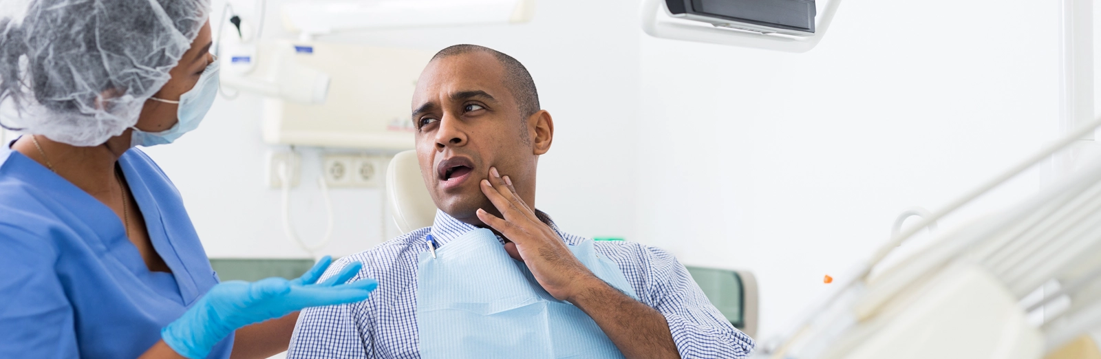 A patient touching his mouth in pain