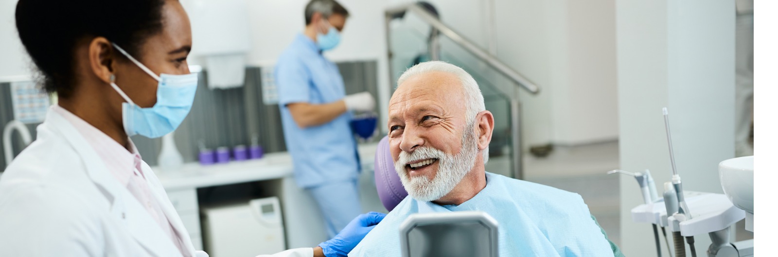 A dentist and patient laughing