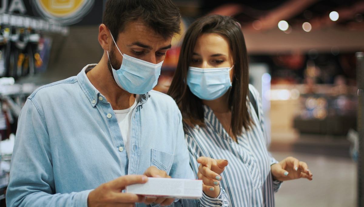 A couple looking at a box of toothpaste
