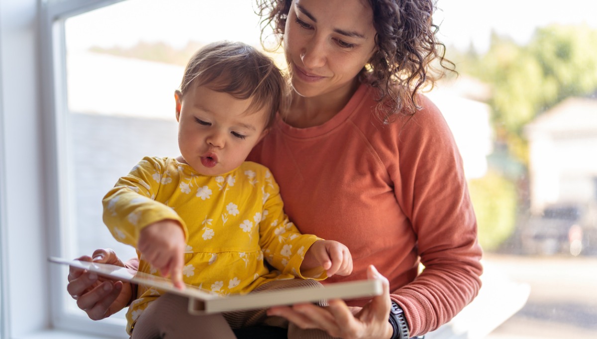 affectionate-mother-reading-book-with-adorable-toddler-daughter-picture-id1200x683.jpg