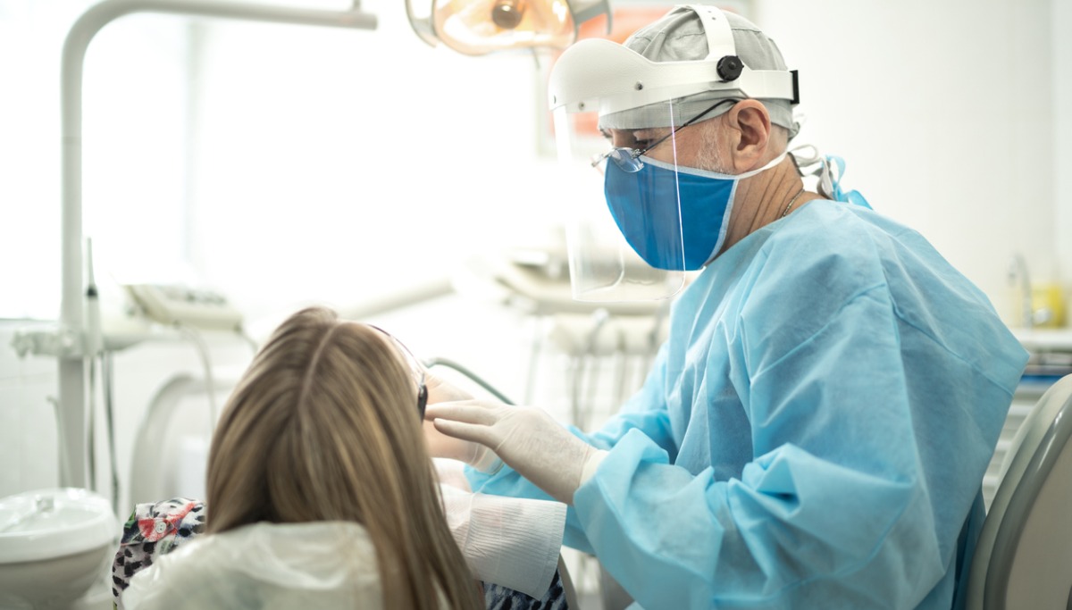senior-dentist-examining-the-teeth-of-a-young-woman-1200x683.jpg