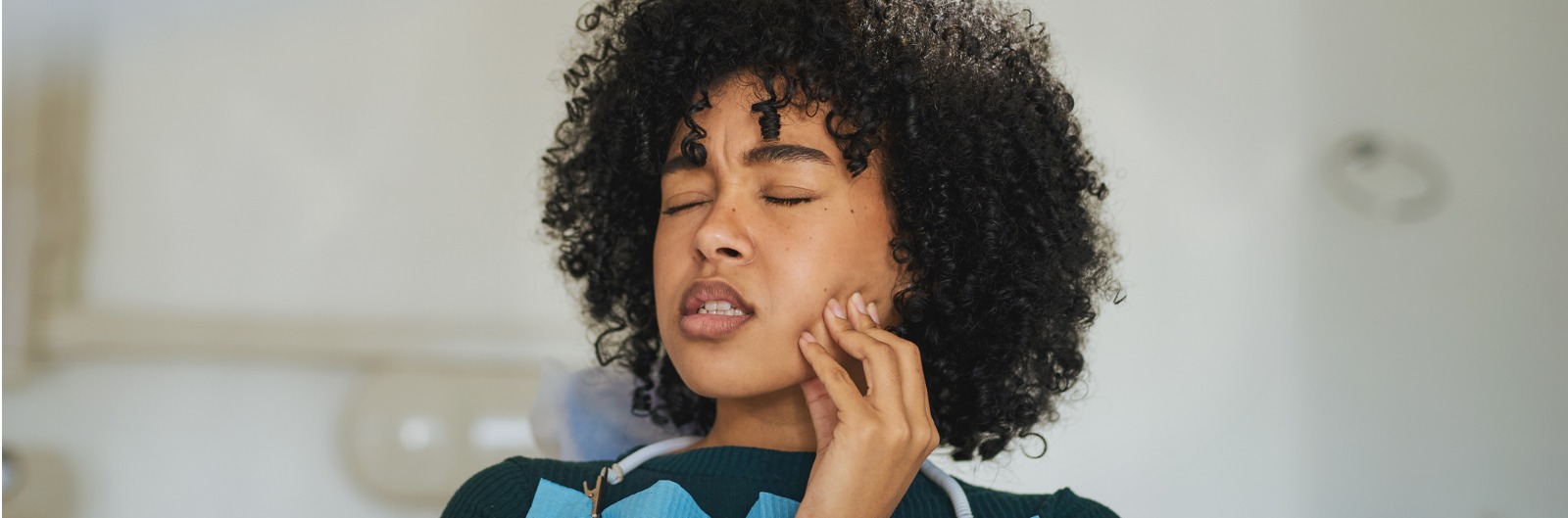 A women touching her jaw in pain