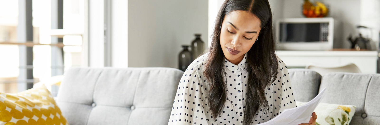 woman-analyzing-bills-while-sitting-at-home-picture- 1600x529.jpg