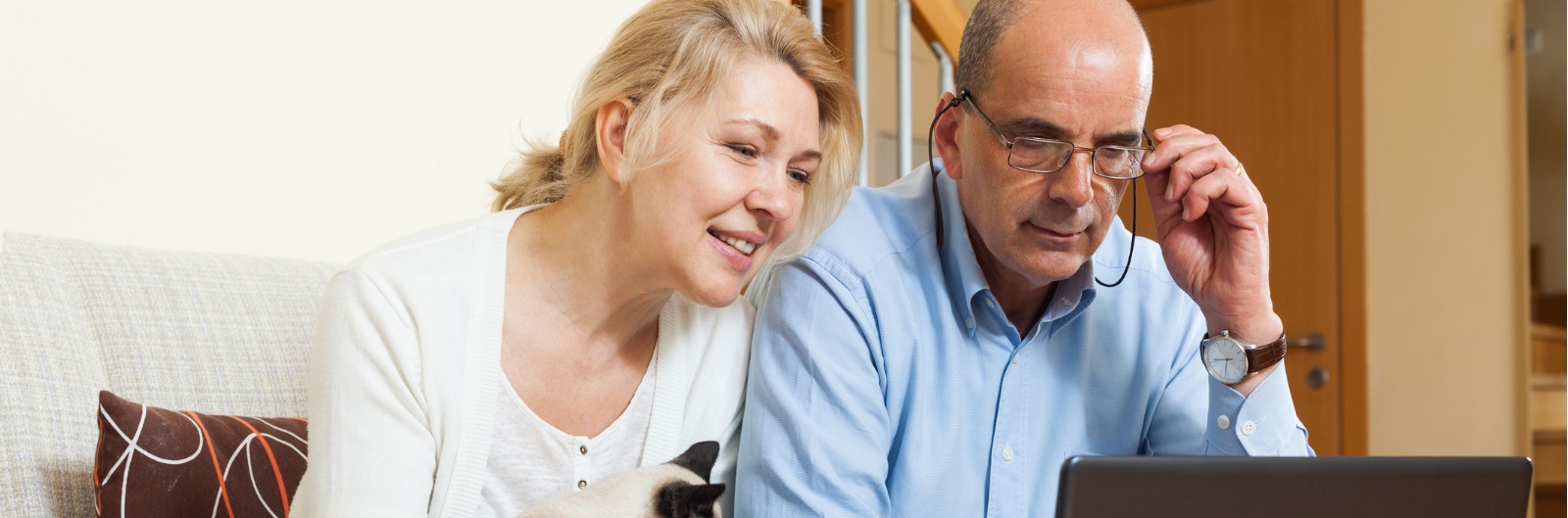 mature-couple-with-laptop-in-home-picture-1600x529.jpg