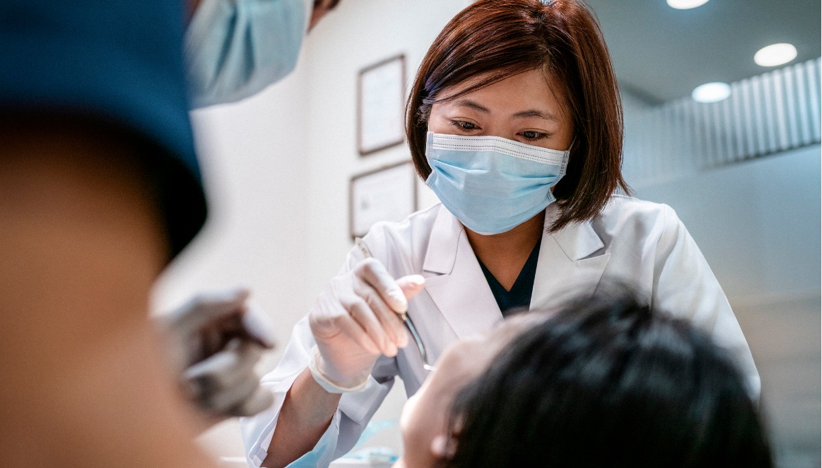 A dentist conducting an exam on a patient