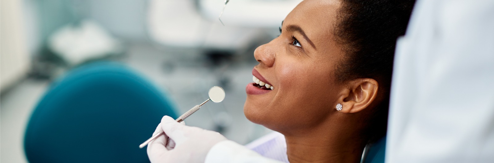 happy-african-american-woman-during-appointment-at-dentist-office-picture-id1340829882.jpg