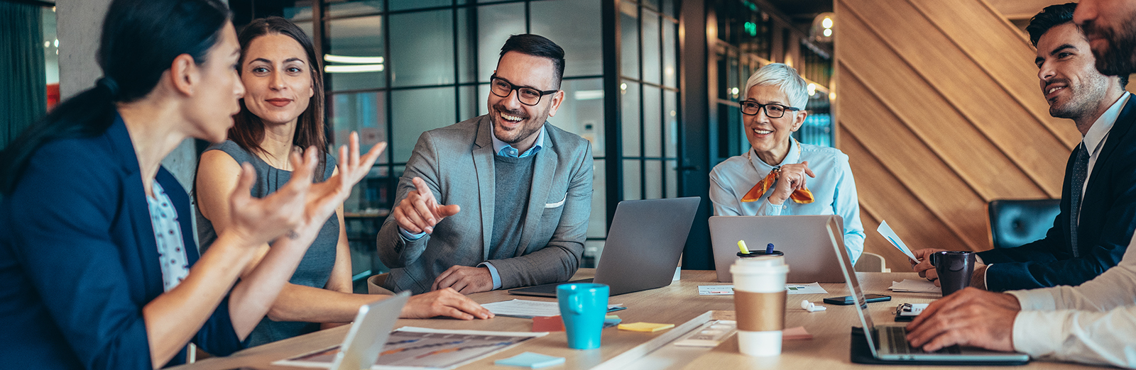 A group of employees talking around a conference table