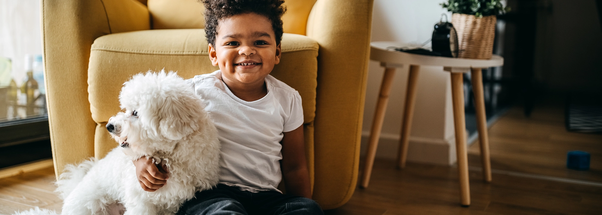 little_boy_smiling_with_dog_2000x714.webp