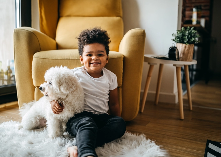 little_boy_smiling_with_dog_767x544.webp