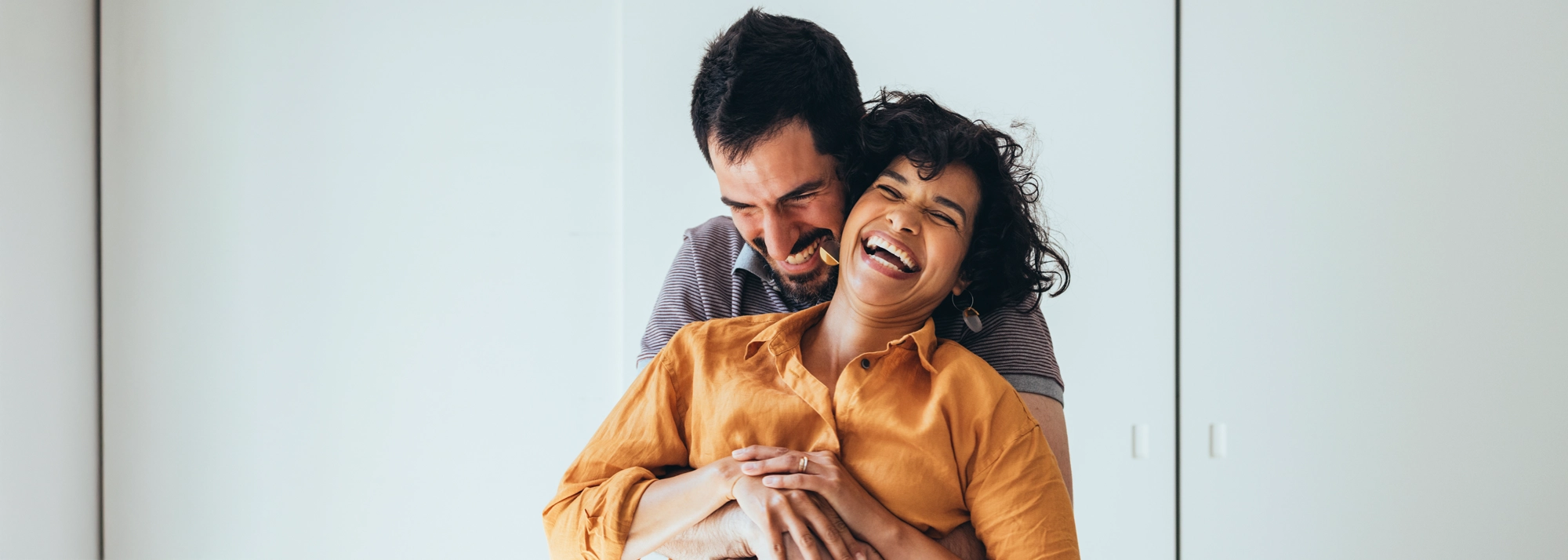 couple_hugging_and_laughing_2000x714.webp