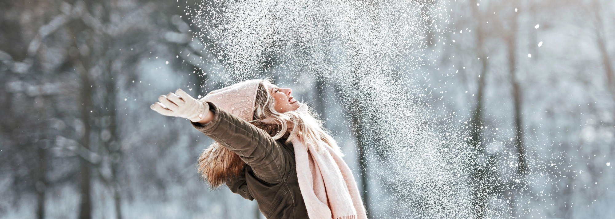 woman-playing in snow-2000x714.webp