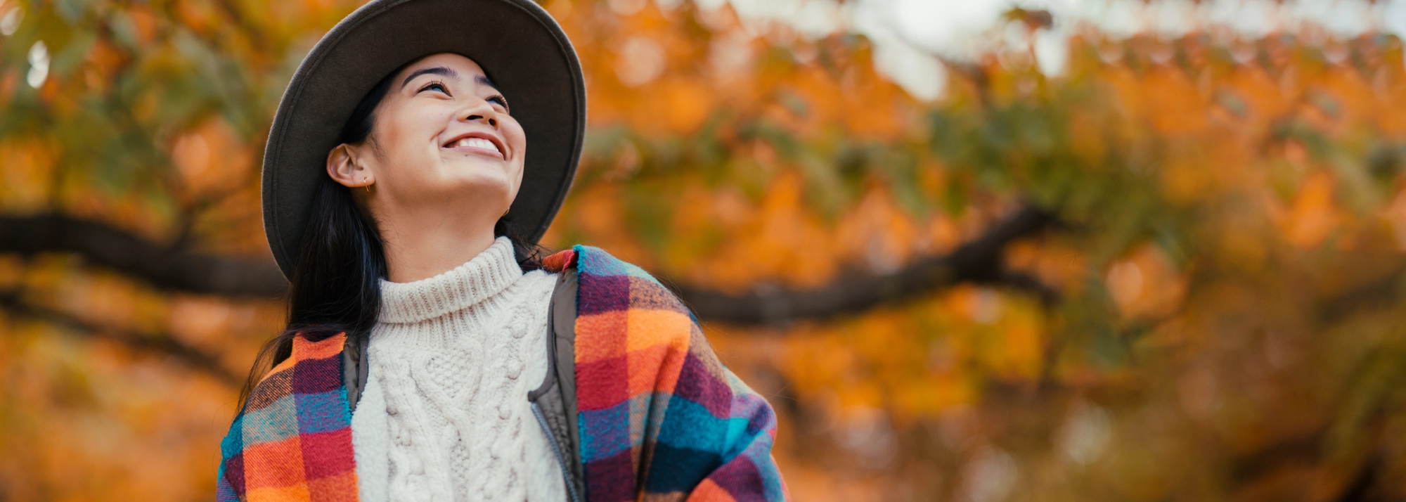 woman-smiling-outside-desktop-2000x714.webp