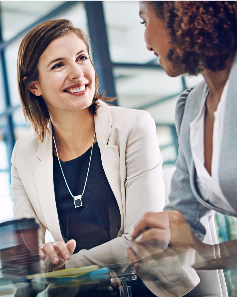 A broker talking with a client at a desk