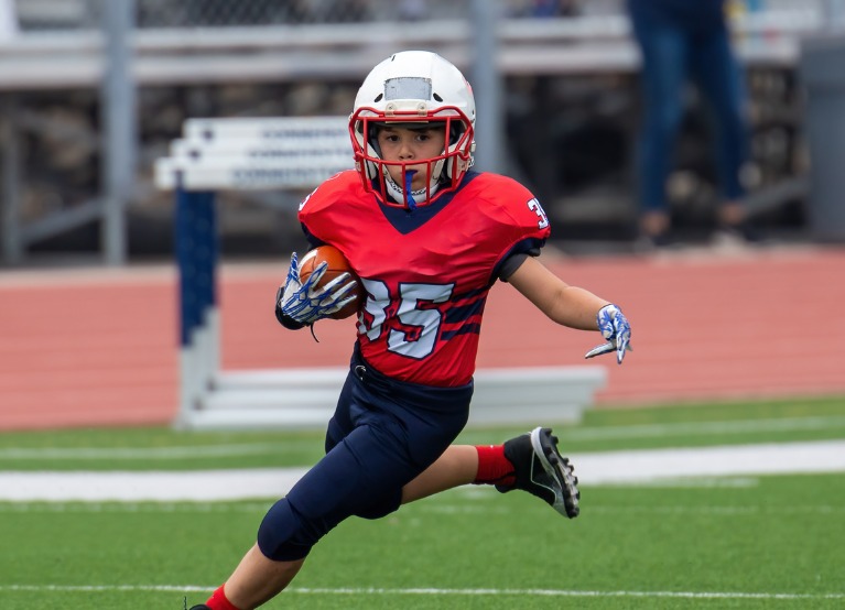 Young football player with a mouth guard