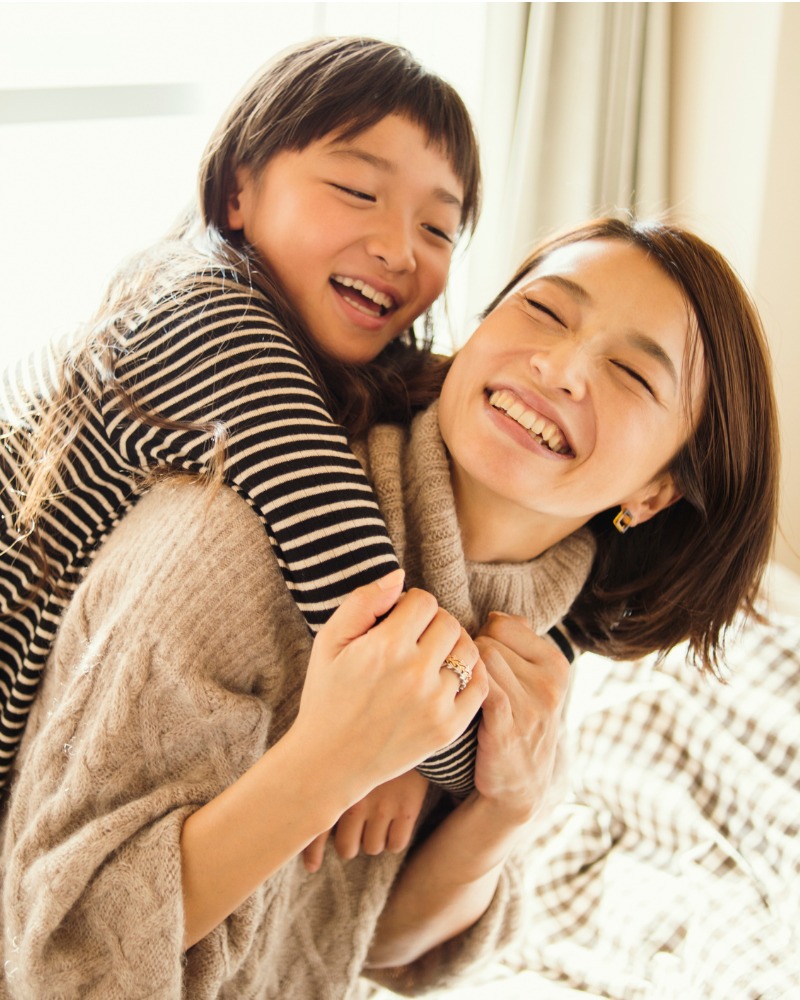 A mother and daughter smiling