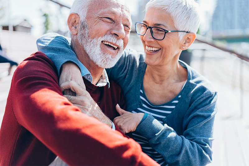 A senior couple smiling