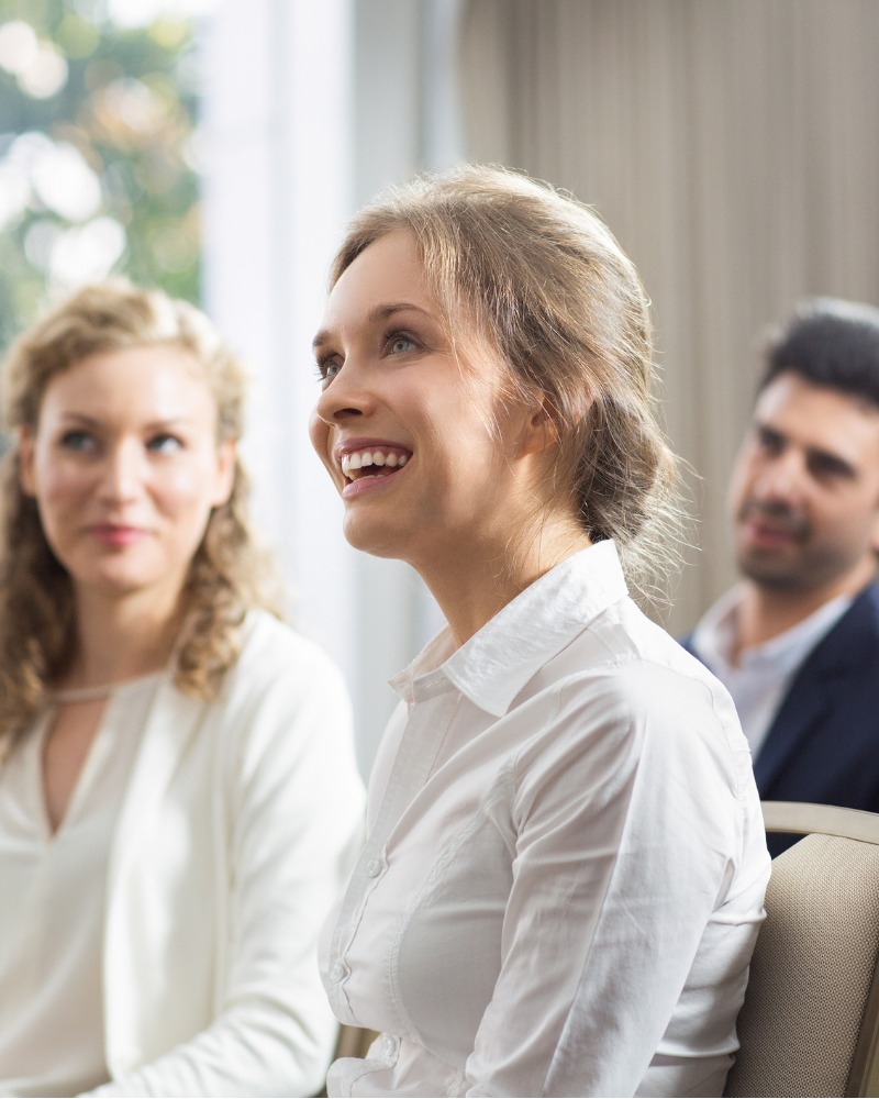 smiling-audience-watching-presentation-picture-800x1000.jpg