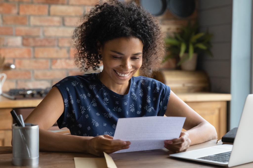 A person sitting at a computer and smiling