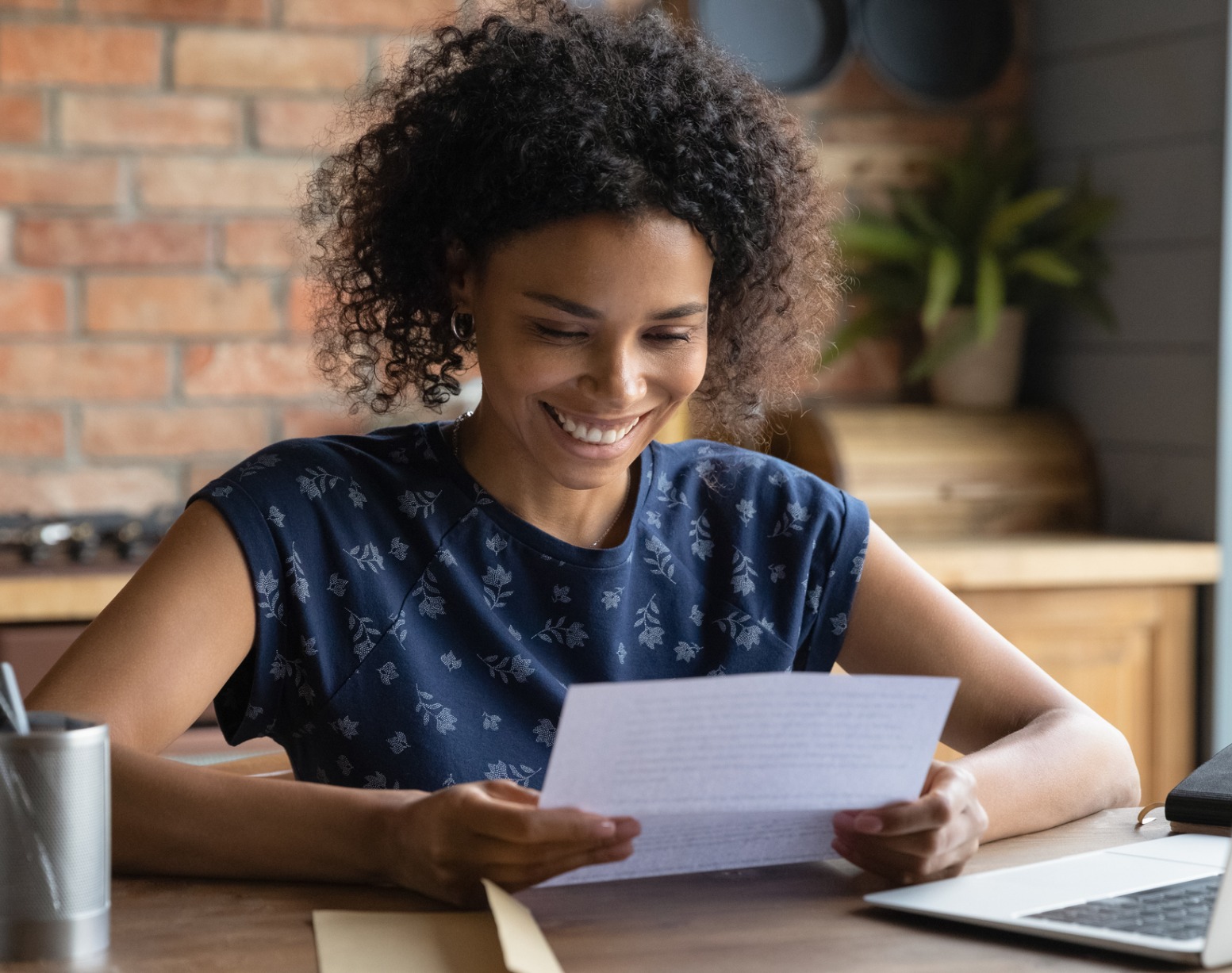 A person sitting at a computer and smiling