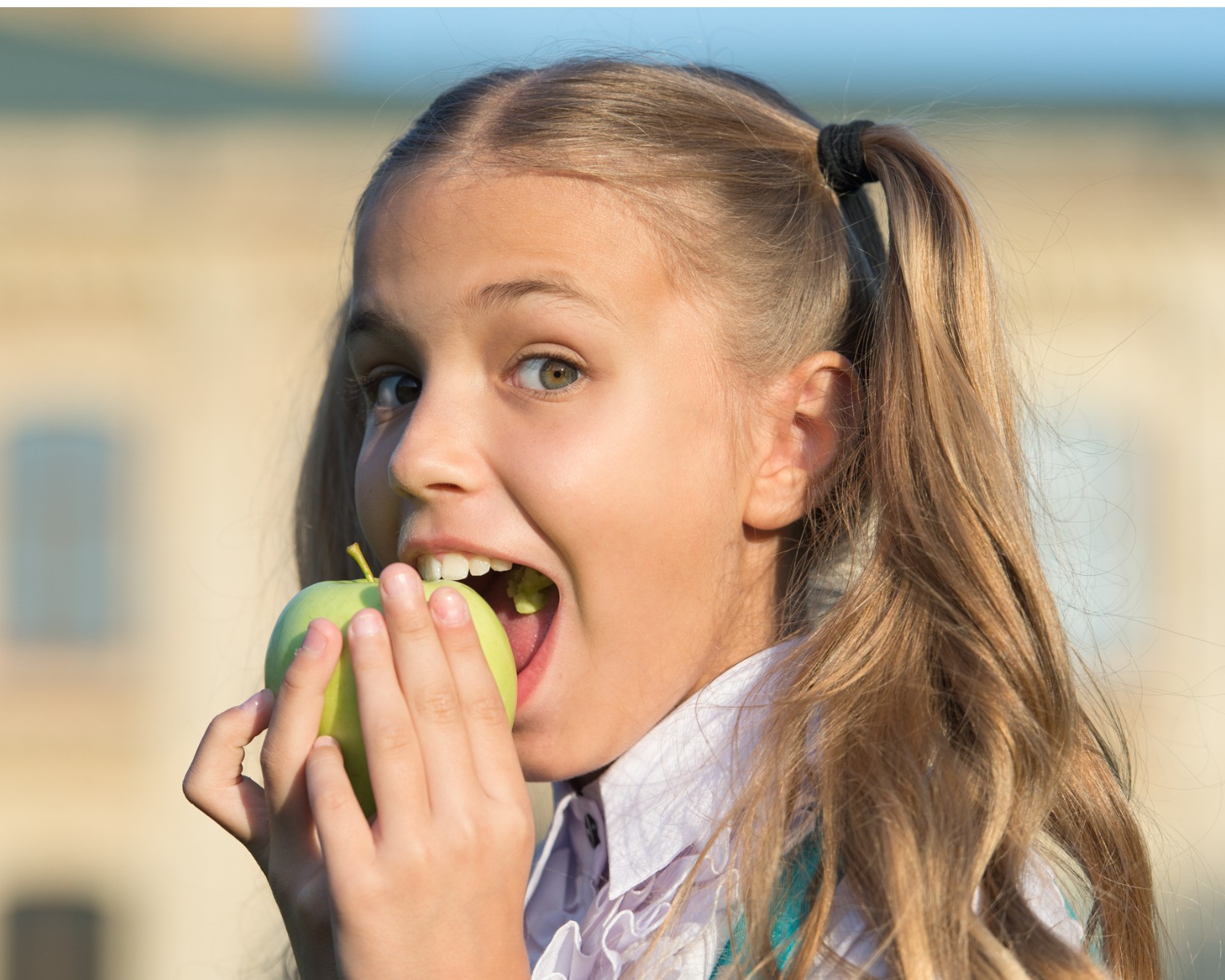 A young child eating an apple