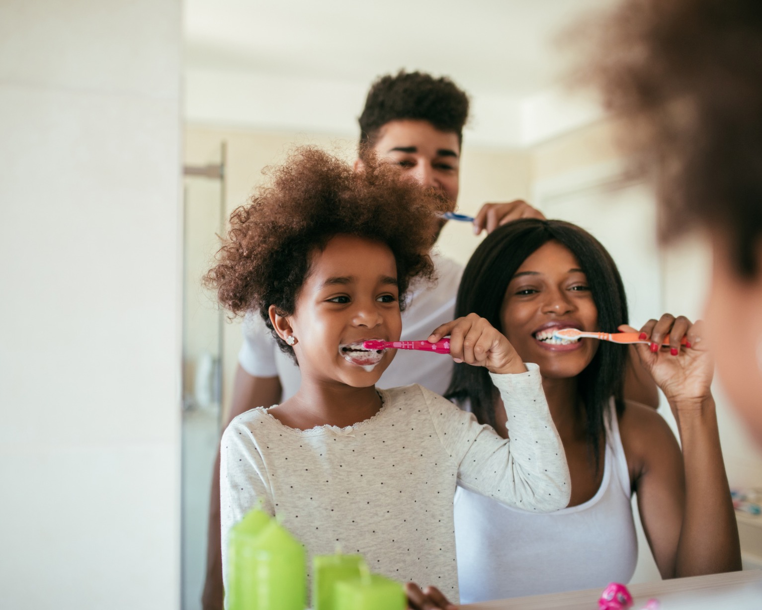 A family brushing their teeth together