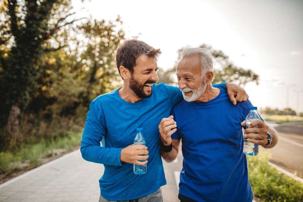 Two family members laughing while walking outside