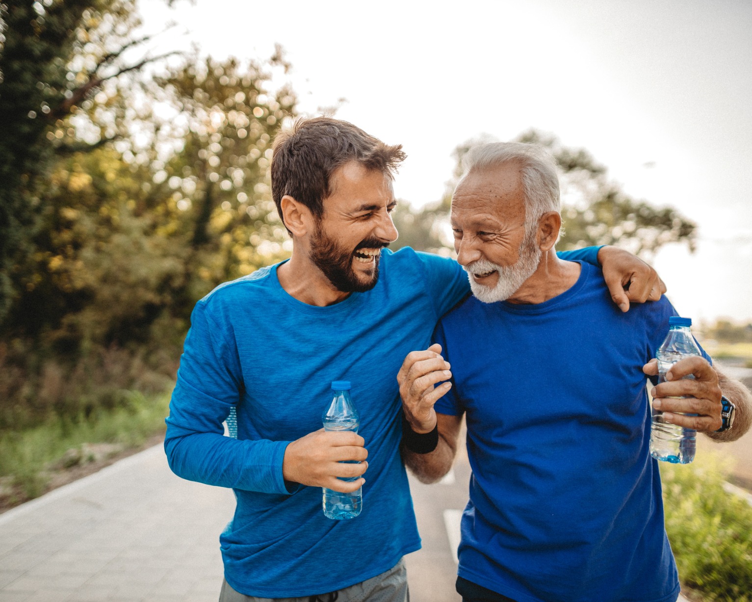 Two family members laughing while walking outside