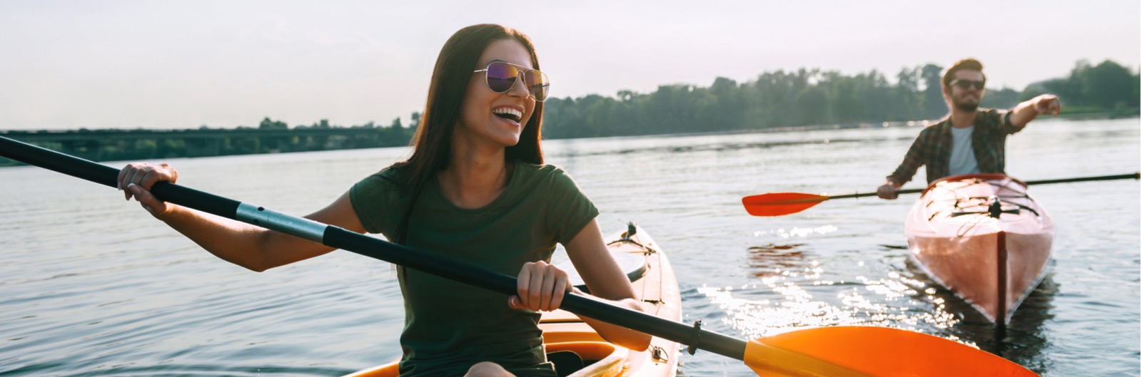 A couple kayaking in the sun