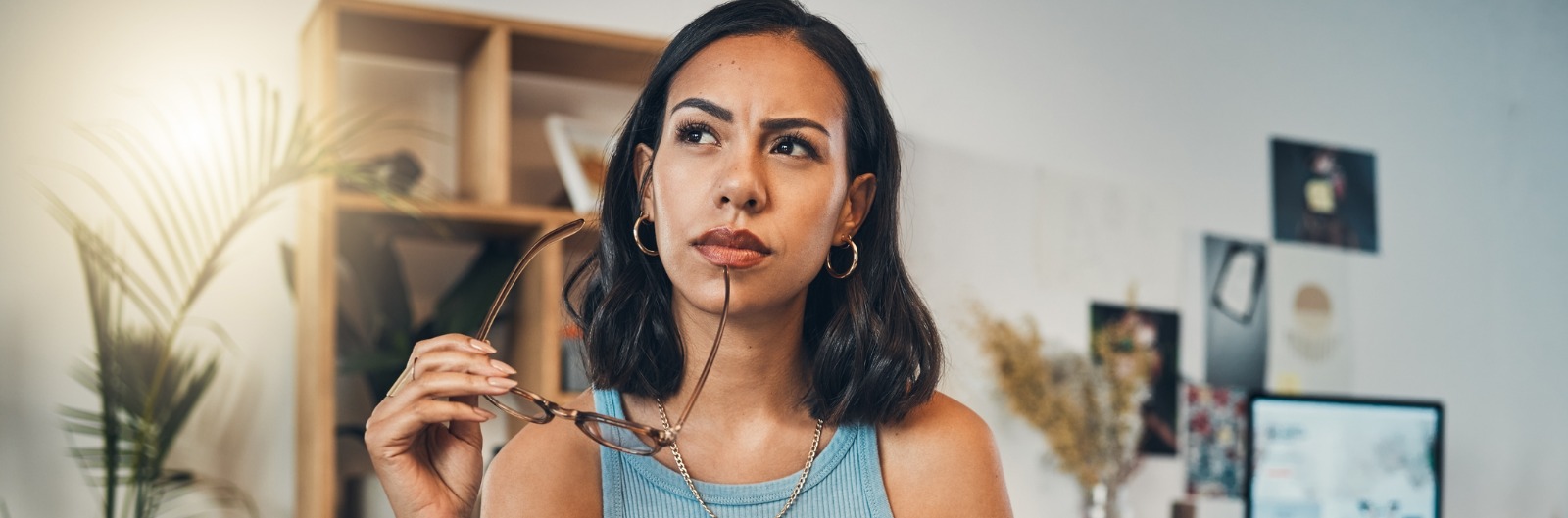 beautiful-mixed-race-woman-thinking-while-using-laptop-for-blogging-in-living-room-at-home_1600x529.jpg