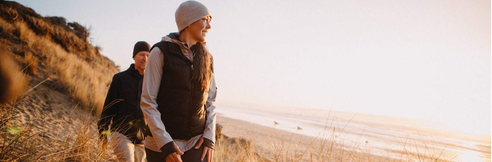 A couple walking along a natural beach