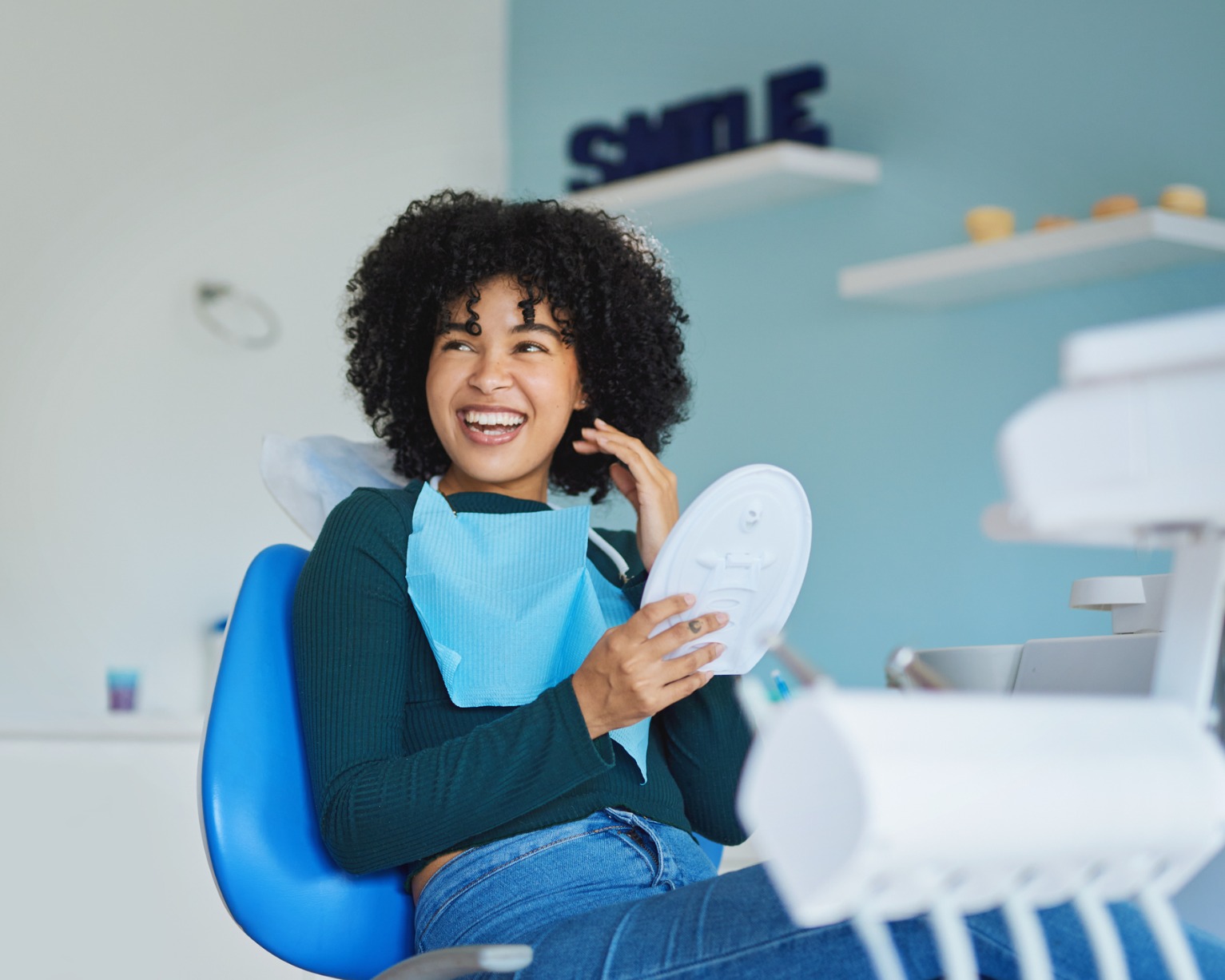 A person in a dentist office smiling