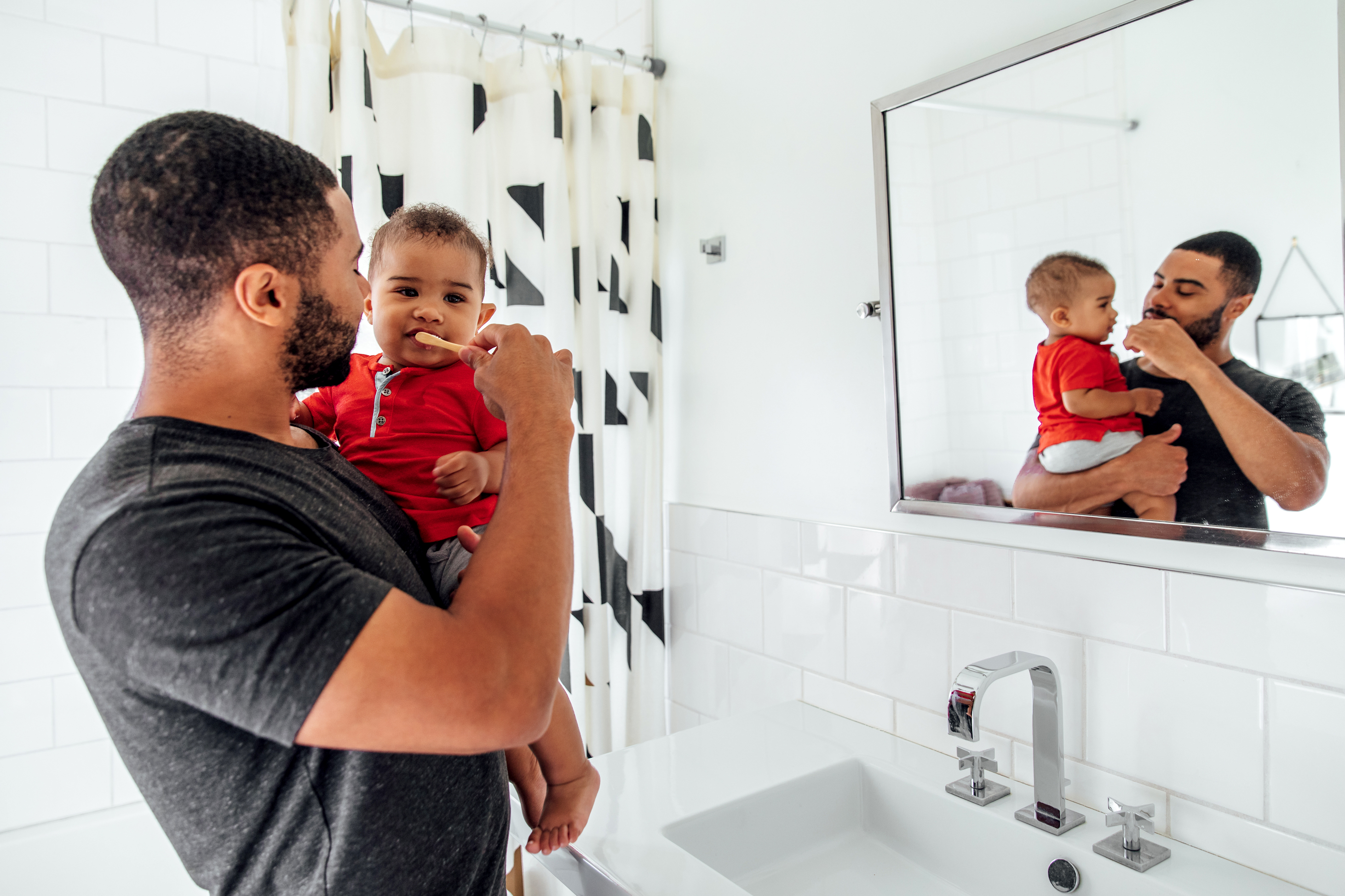 Father Brushes Son's Teeth