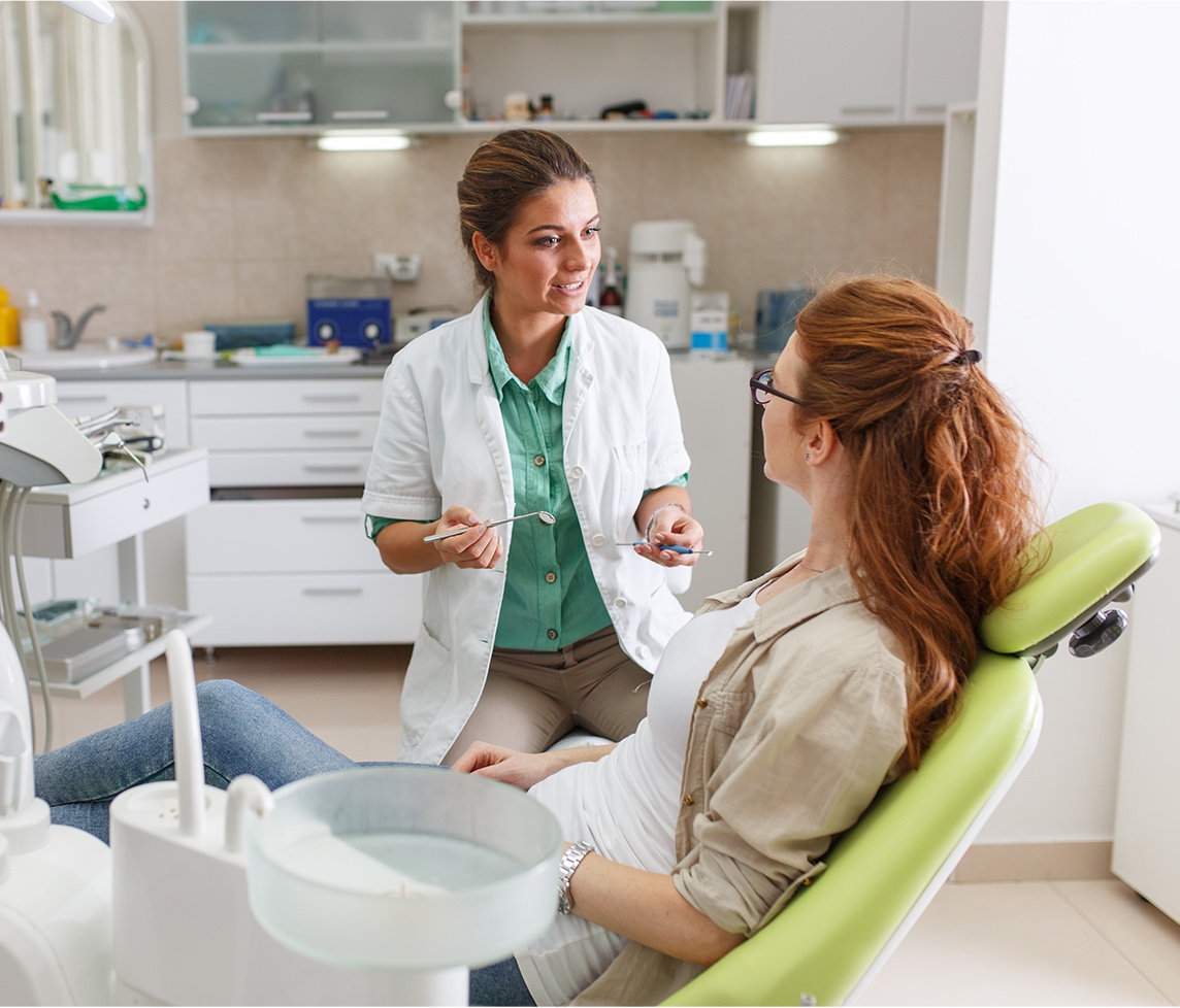 woman dentist talking with patient 1144x978 .jpg