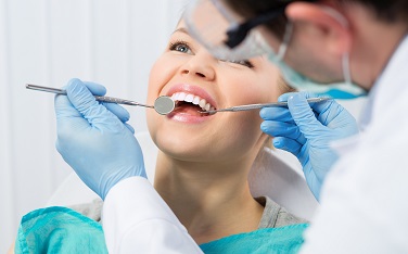 Regular dentist visit. Caries cure. Young woman visiting dentist