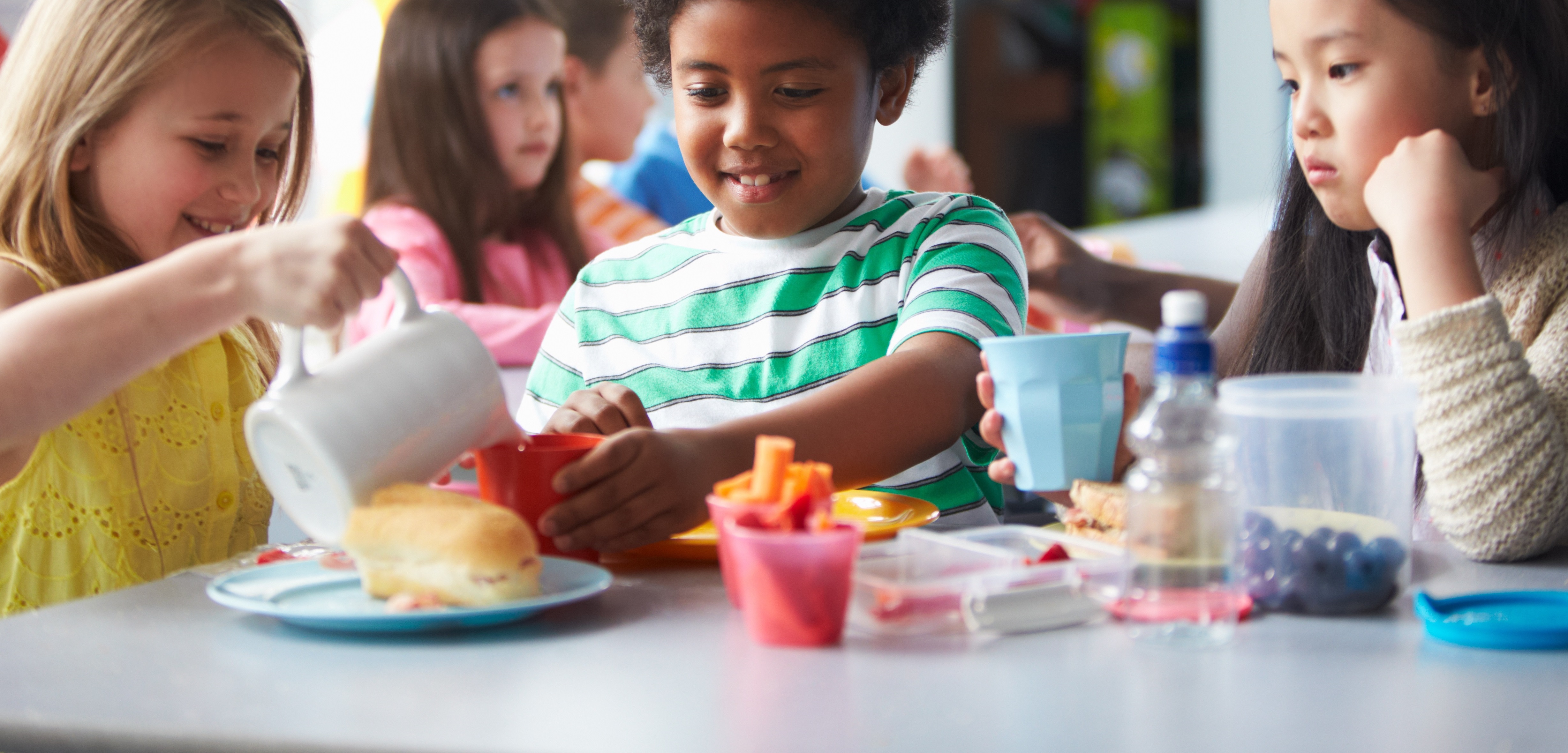 Group Of Children Eating Lunch In School Cafeteria