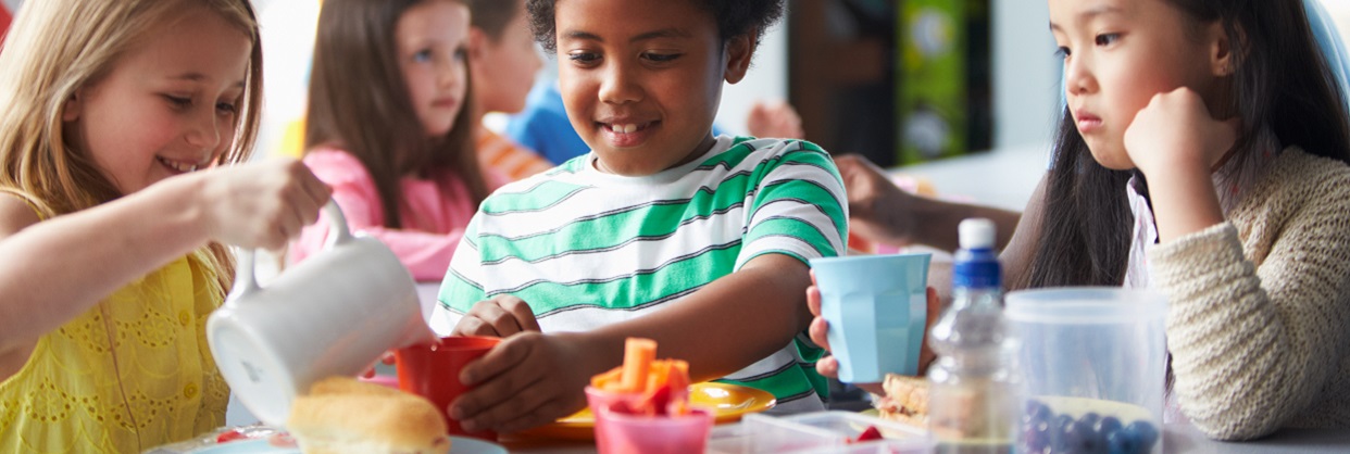 Group Of Children Eating Lunch In School Cafeteria