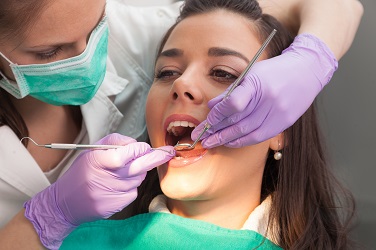 Dentist examining a patient's teeth in the dentist