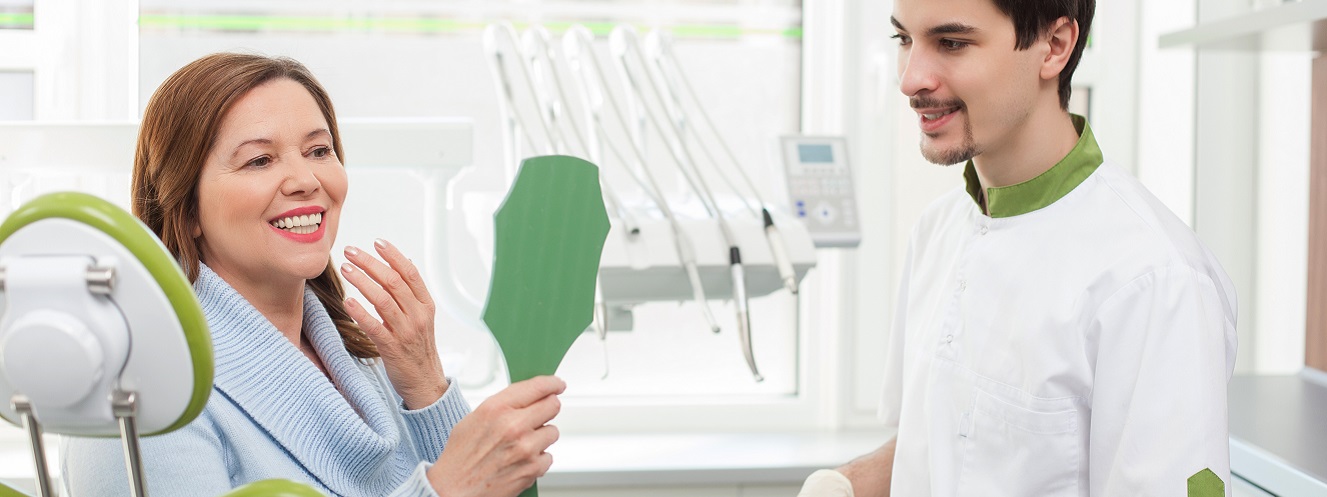 Skillful male dental doctor is working with patient