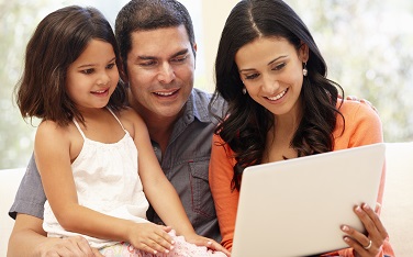 Hispanic family with laptop at home
