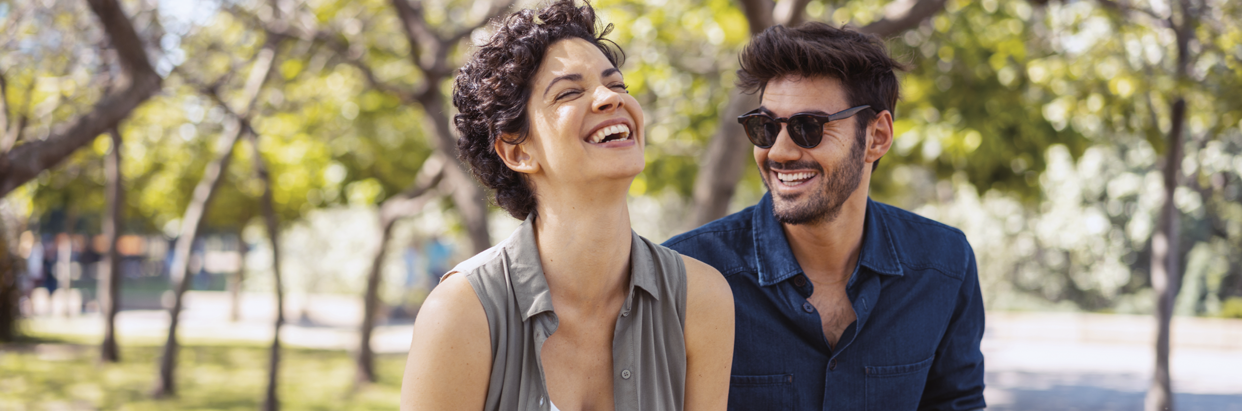 couple-smiling-outside-1242x411.png