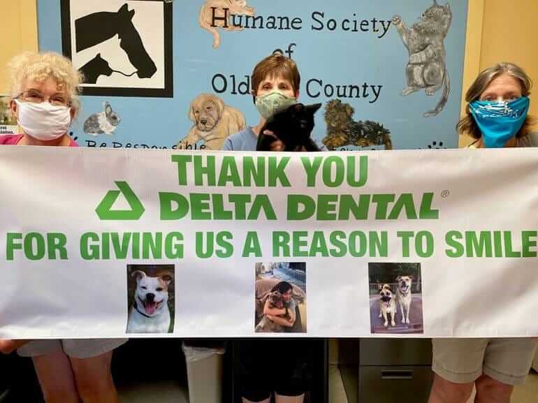 oldham community humane society volunteers with thank you sign.jpg