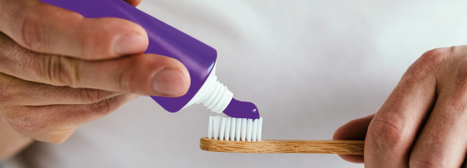 purple-toothpaste-on-a-toothbrush-1600x578.webp